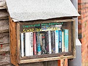 Street book swap library made from floorboards, decking and fridge shelf